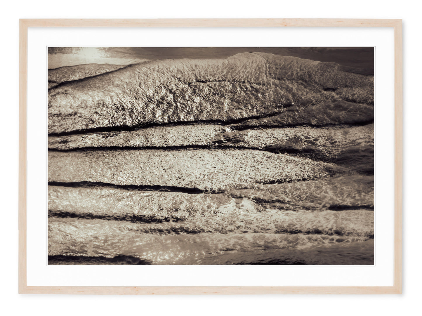 neutral tone landscape image of contrasty waves on shore