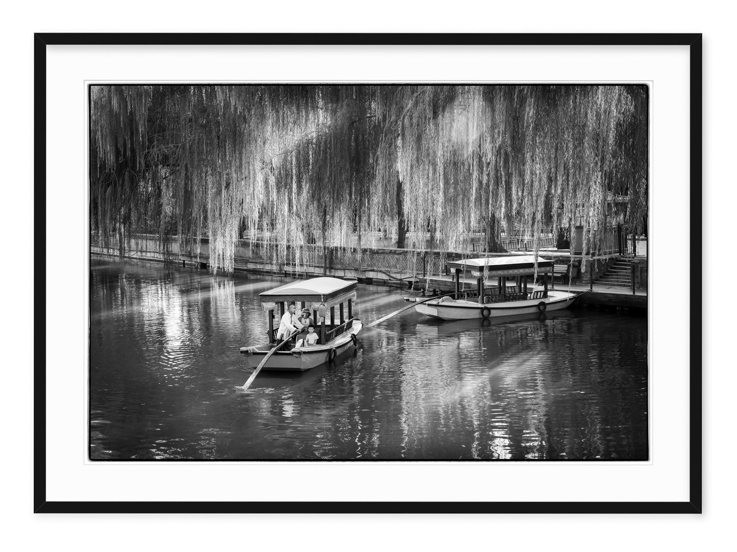 family on a traditional boat tour a beijing lake in dappled sunlight
